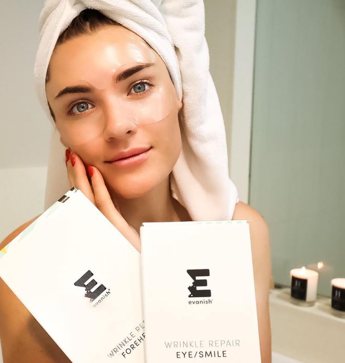Woman's using wrinkle reducing strips on forehead