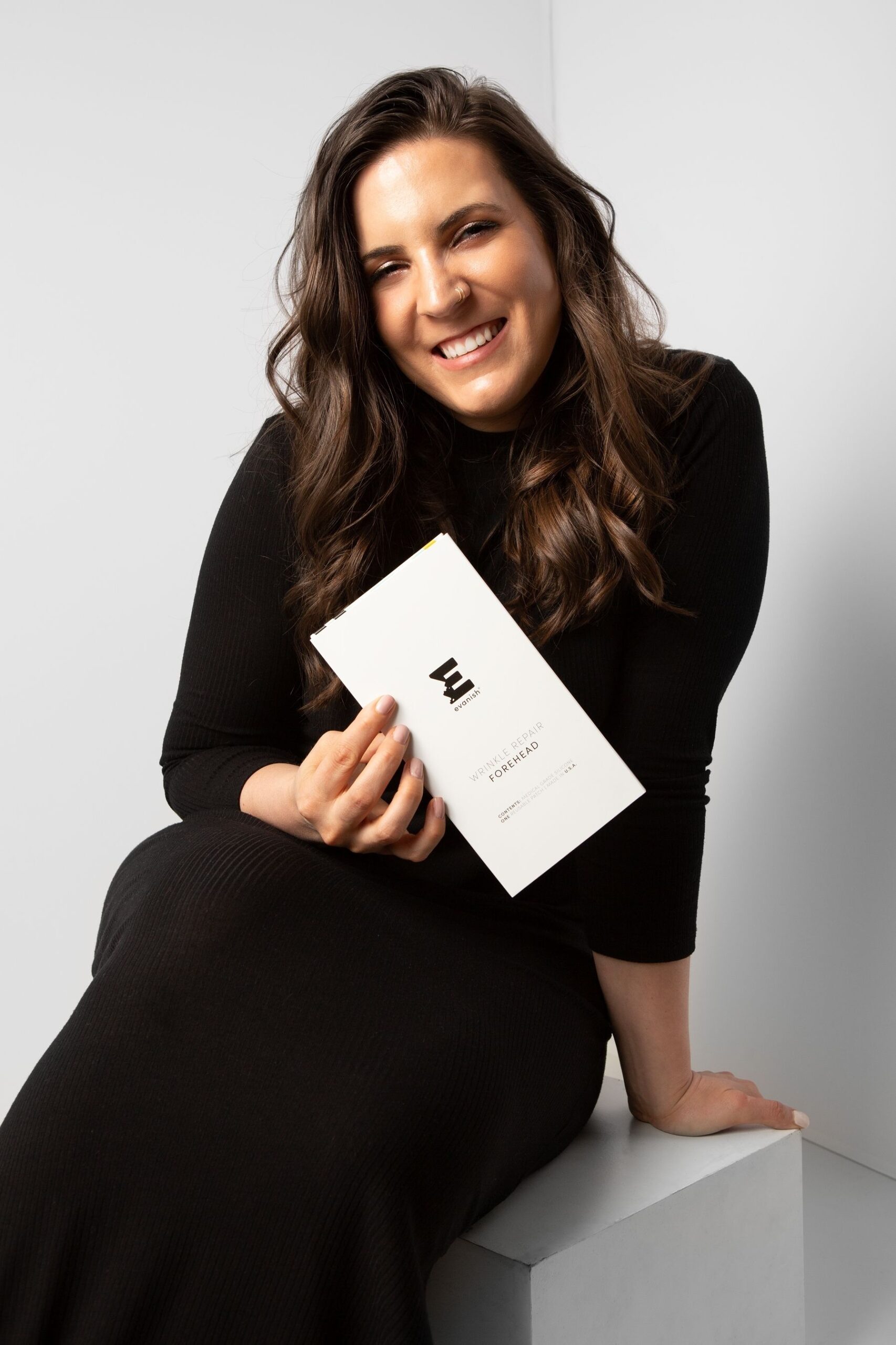 Evanish Skincare founder holding anti wrinkle patches