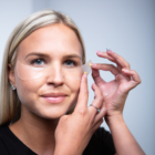 Woman applying under eye patches